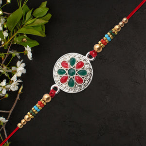 Silver Plated Floral Rakhi With Red Green Stones