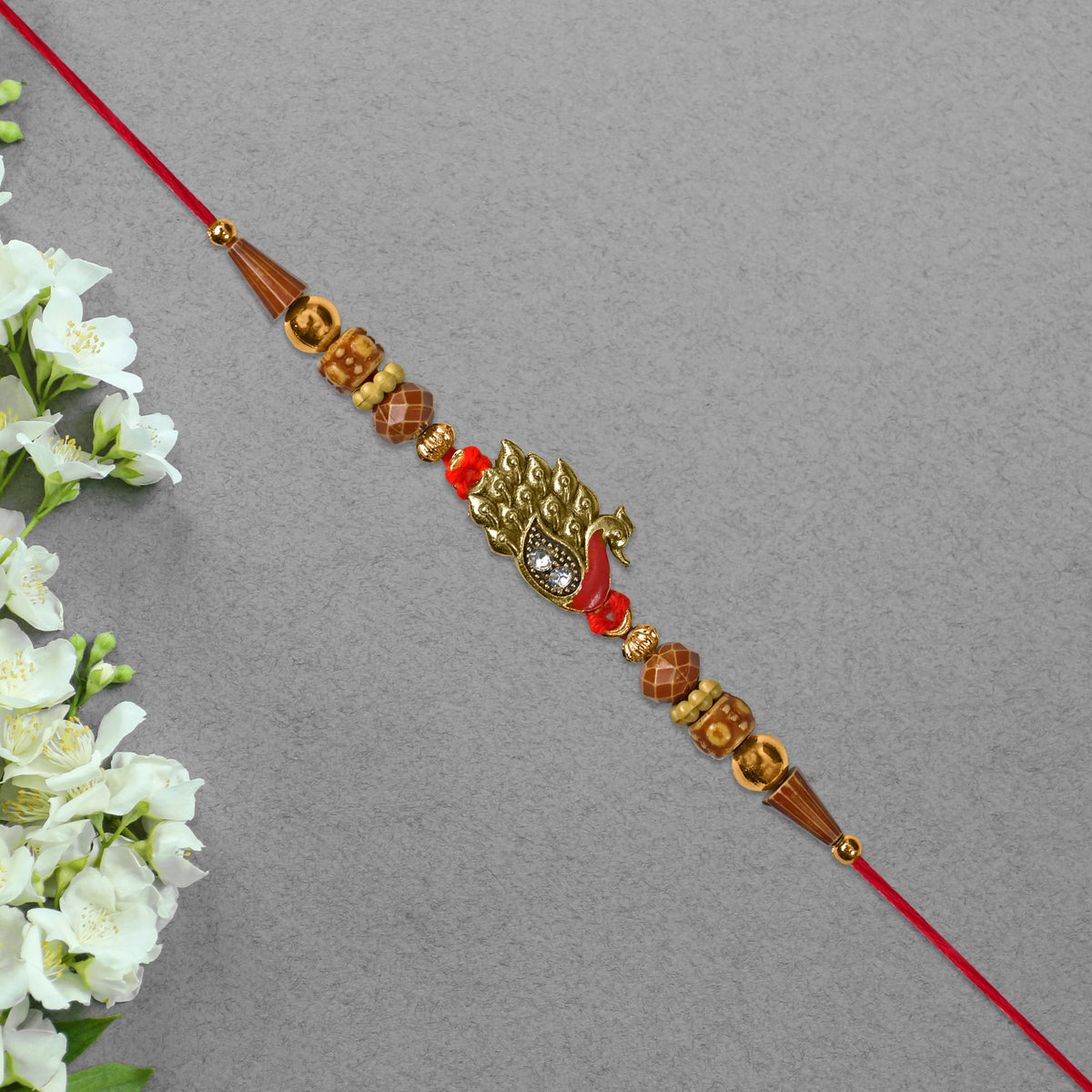 Antique Peacock Feather Rakhi With Beaded Thread